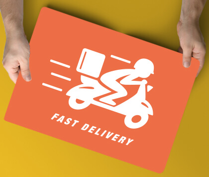 An orange promotional fast food delivery magnetic sign held in hand.